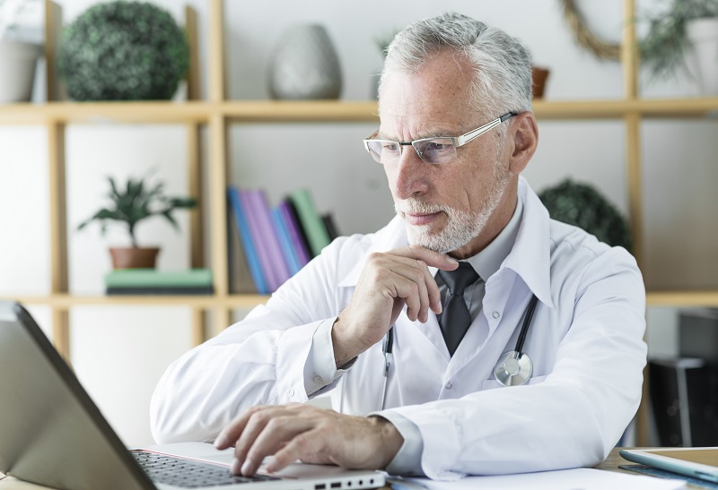 A Physician Working on laptop