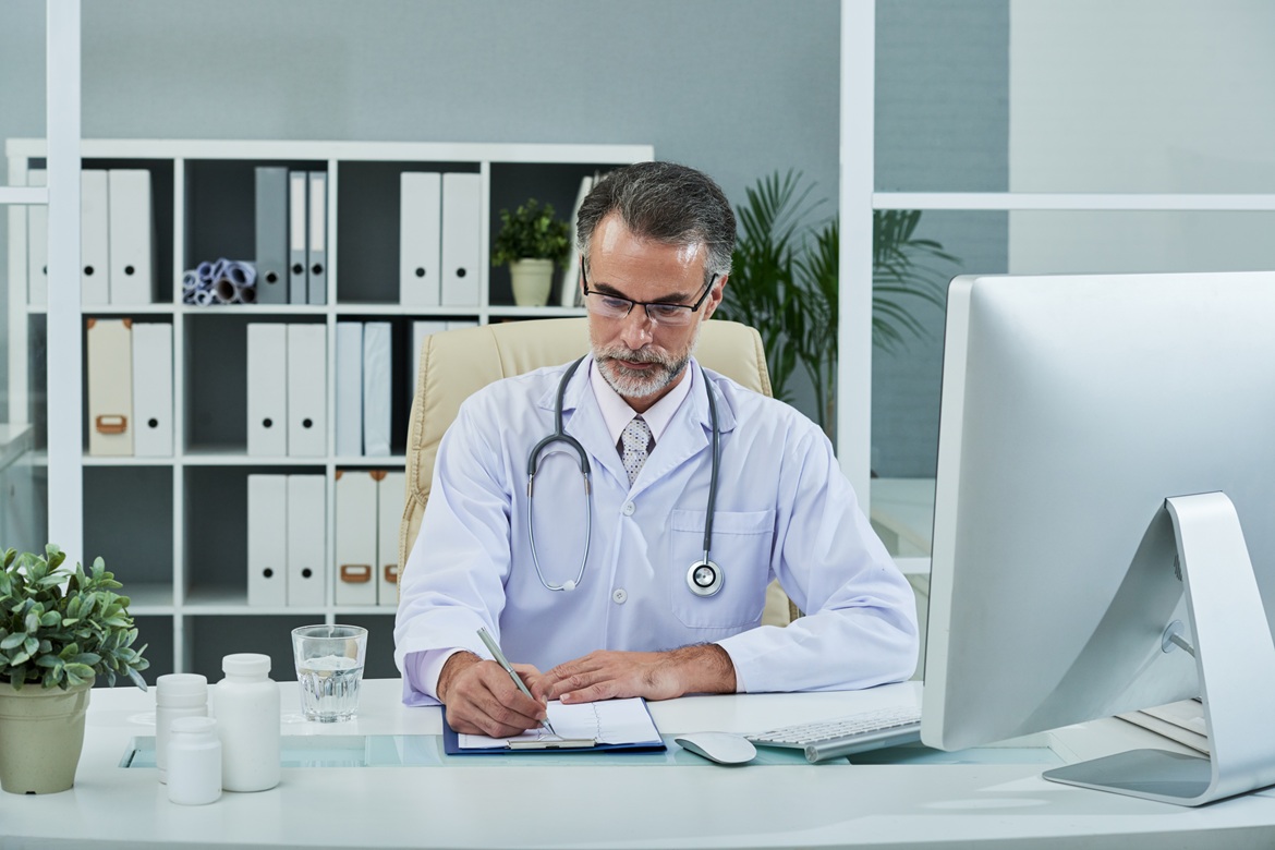 Physician reviewing a patient's care plan at a desk